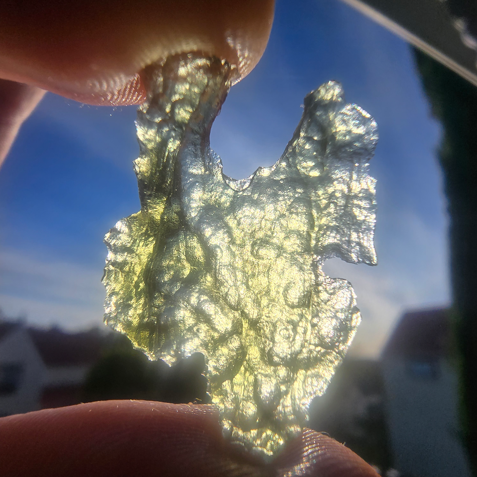 Thumbnail: Libyan Desert Glass Pendant held to light