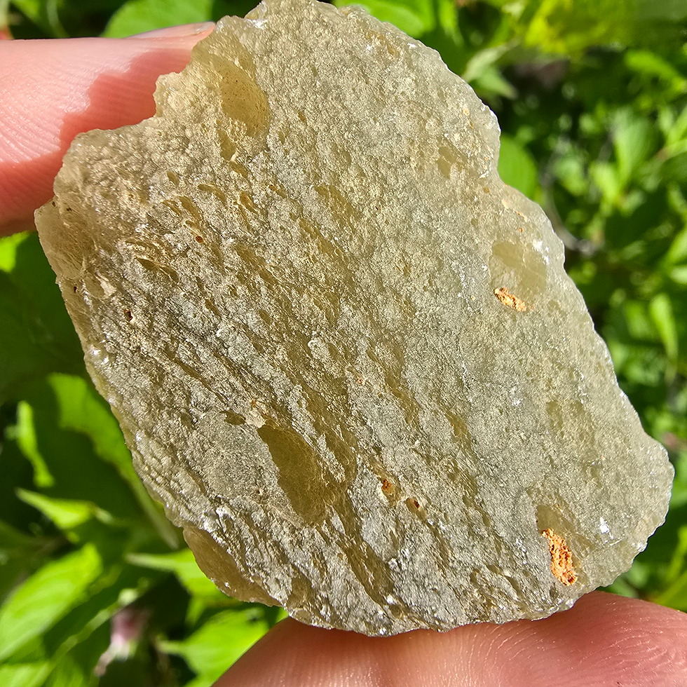 Thumbnail: Raw Libyan Desert Glass specimen held in hand