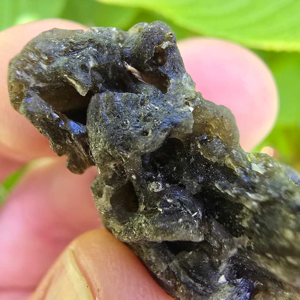 Thumbnail: Hand holding Moldavite 1.94g
