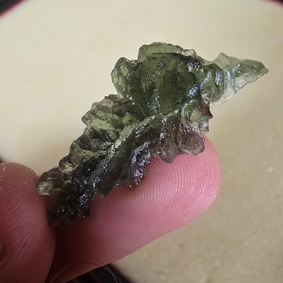 Thumbnail: Green, textured Moldavite 1.24g held in fingers