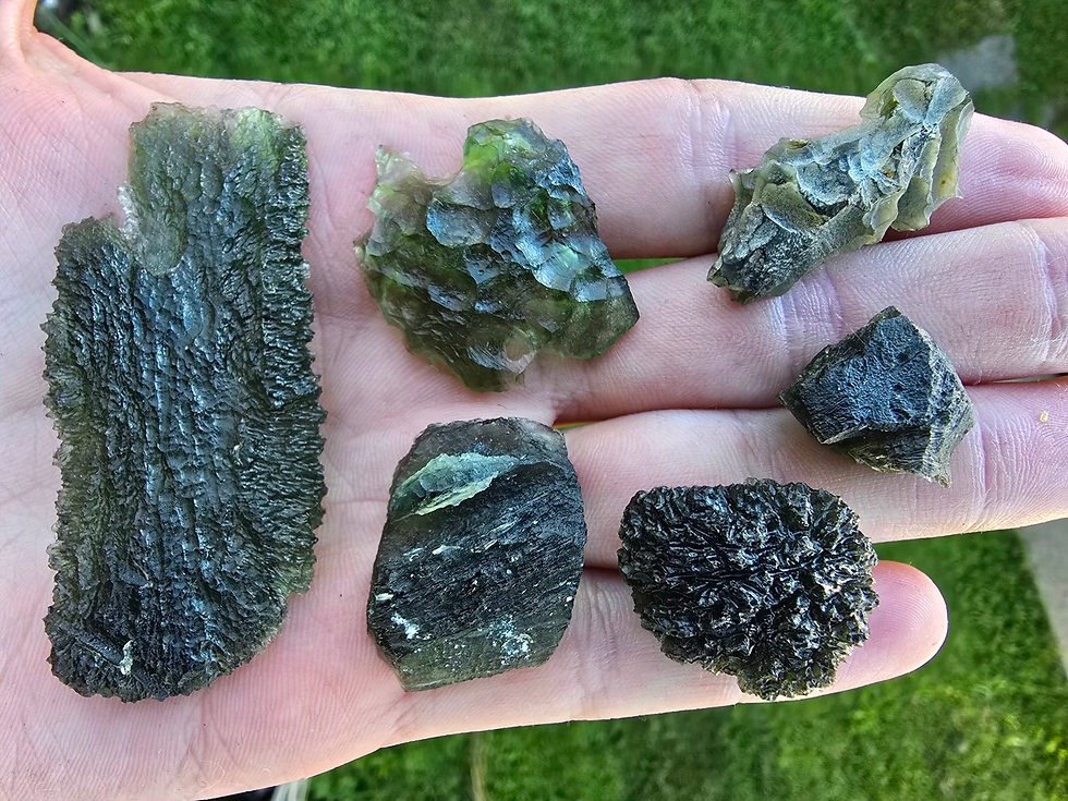 Genuine Moldavite pieces showing natural variation in shape, texture and green colour