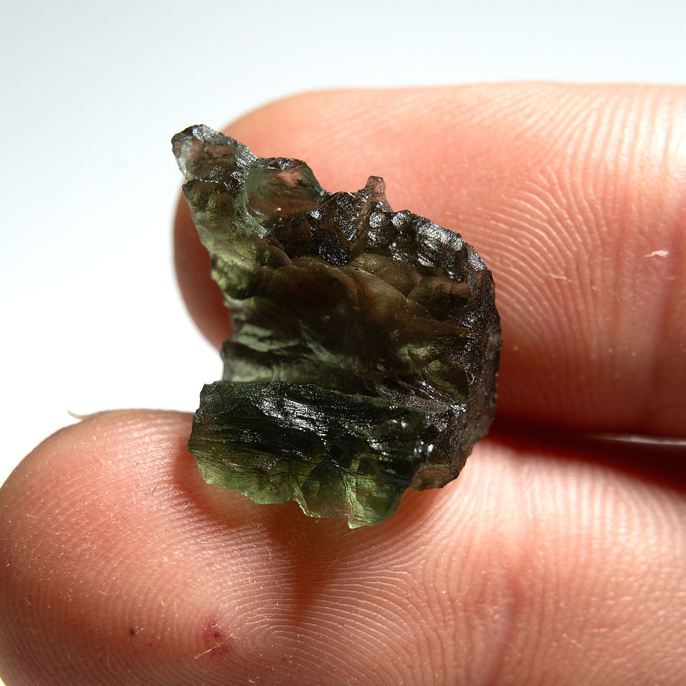 Thumbnail: Rough dark green Moldavite in fingers
