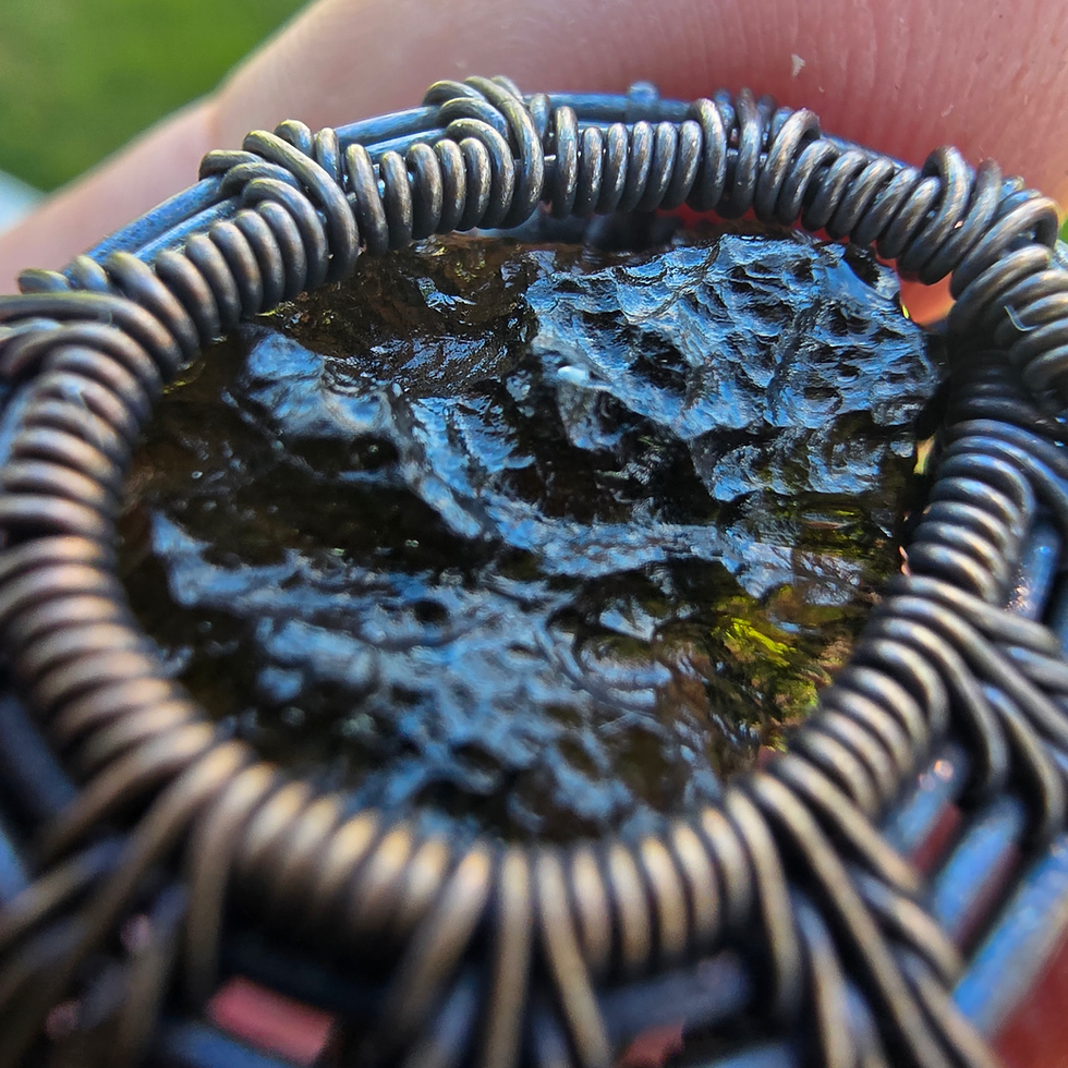 Thumbnail: Close-up of a textured Moldavite stone in wire wrapping