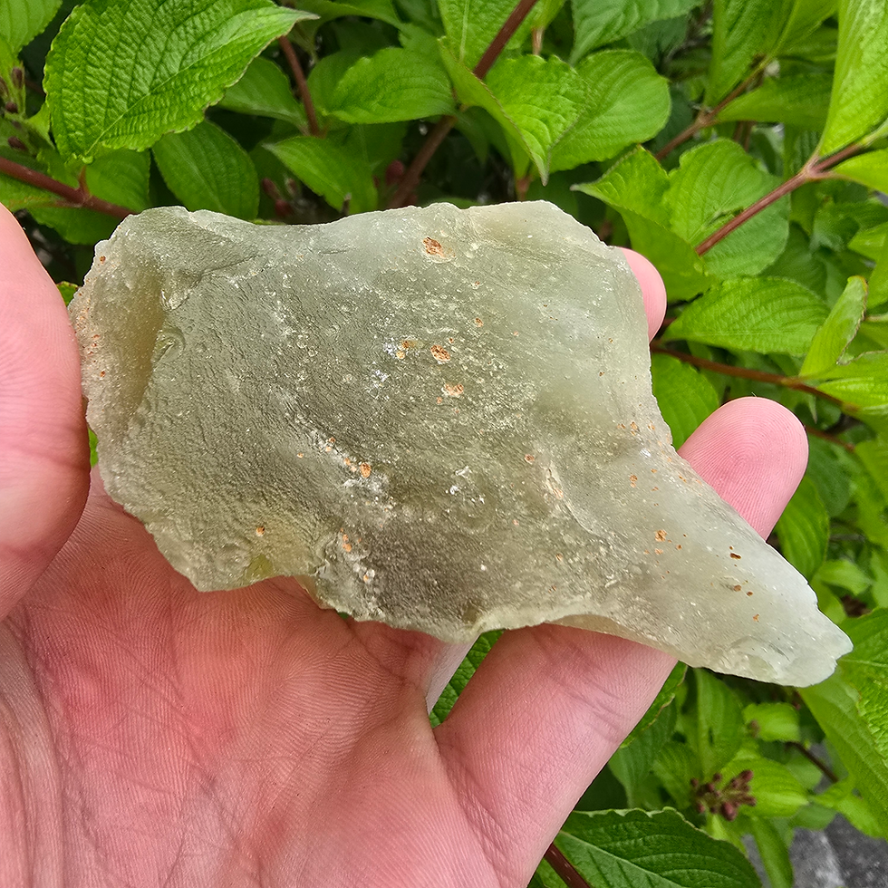 Thumbnail: Hand holding raw Libyan Desert Glass