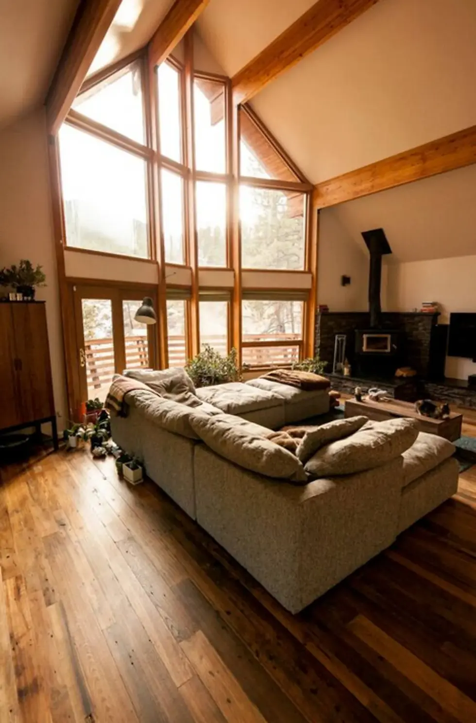 Boulder corporate wellness retreat meeting space with mountain views through floor-to-ceiling windows, wooden beams, and
