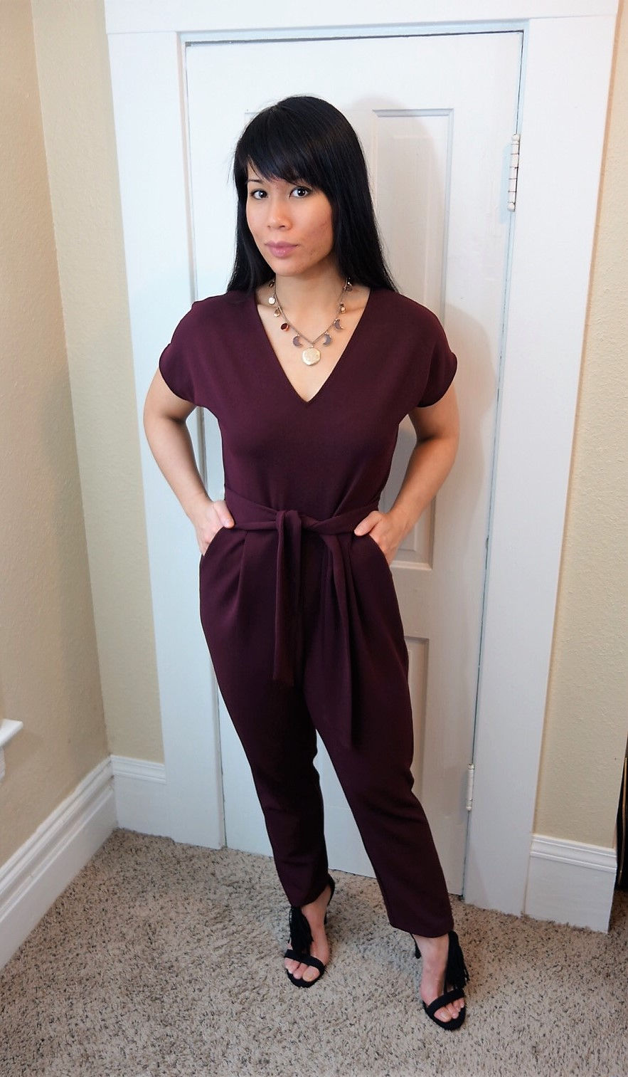 Kat Depner wearing a deep red jumpsuit for date night