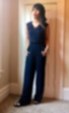 Kat posing in blue jumpsuit for a slimming effect