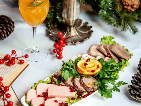 A festive dining table spread featuring a nutrient dense pomegranate salad and lean protein platters for healthy entertaining.