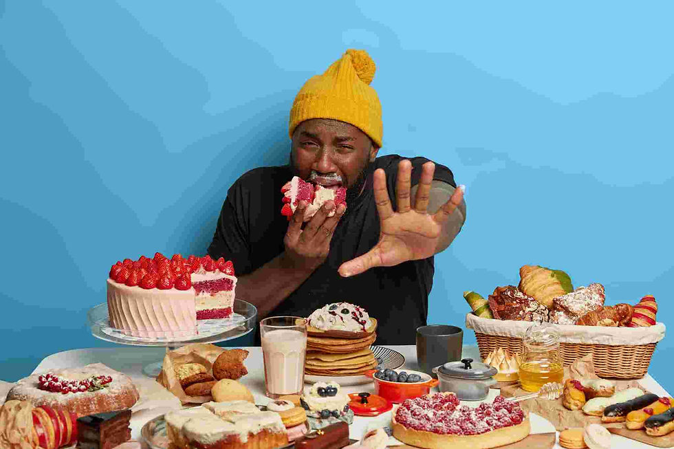 Person looking anxious and stressed while surrounded by junk food, showing fear and craving emotions