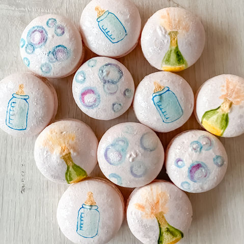 Baby shower macarons with painted champagne bottles and bubbles