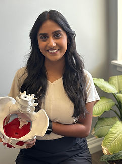 Dr. Richa Patel holding a pelvic model