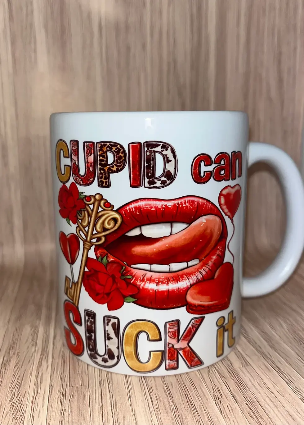 Thumbnail: White mug with red lips, gold key, and 'CUPID can SUCK my...' text