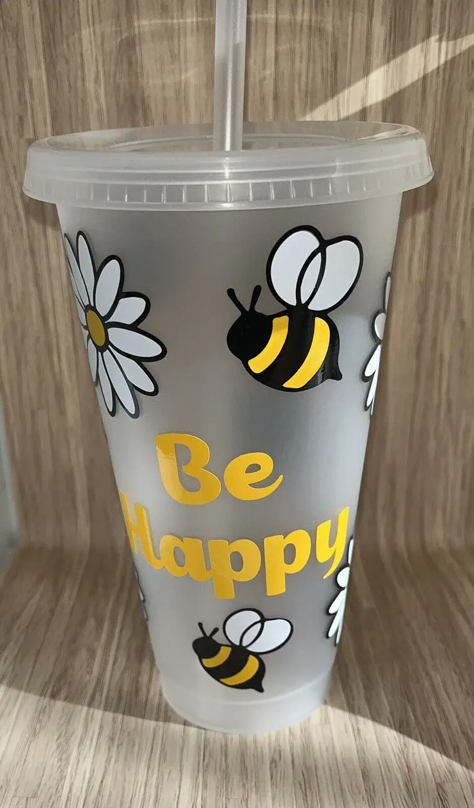 Reusable cup with daisies, bees, and "Be Happy"