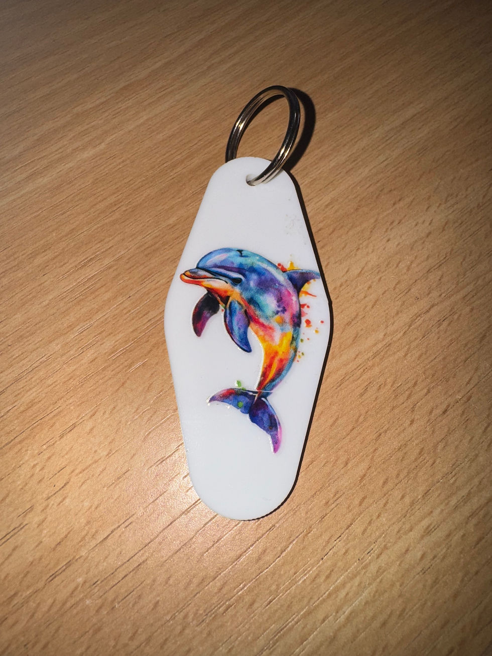 Thumbnail: White keyring with colorful leaping dolphin