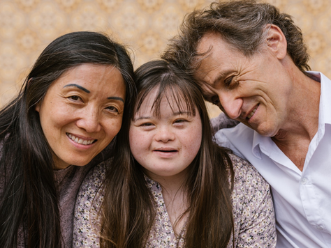 A family of three, one with a visible intellectual disability