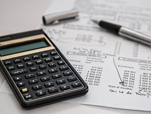 Une calculatrice et un stylo sur une feuille de papier