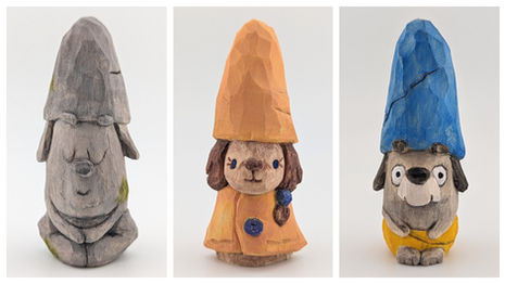 a wood carving of a dog wearing a yellow coat