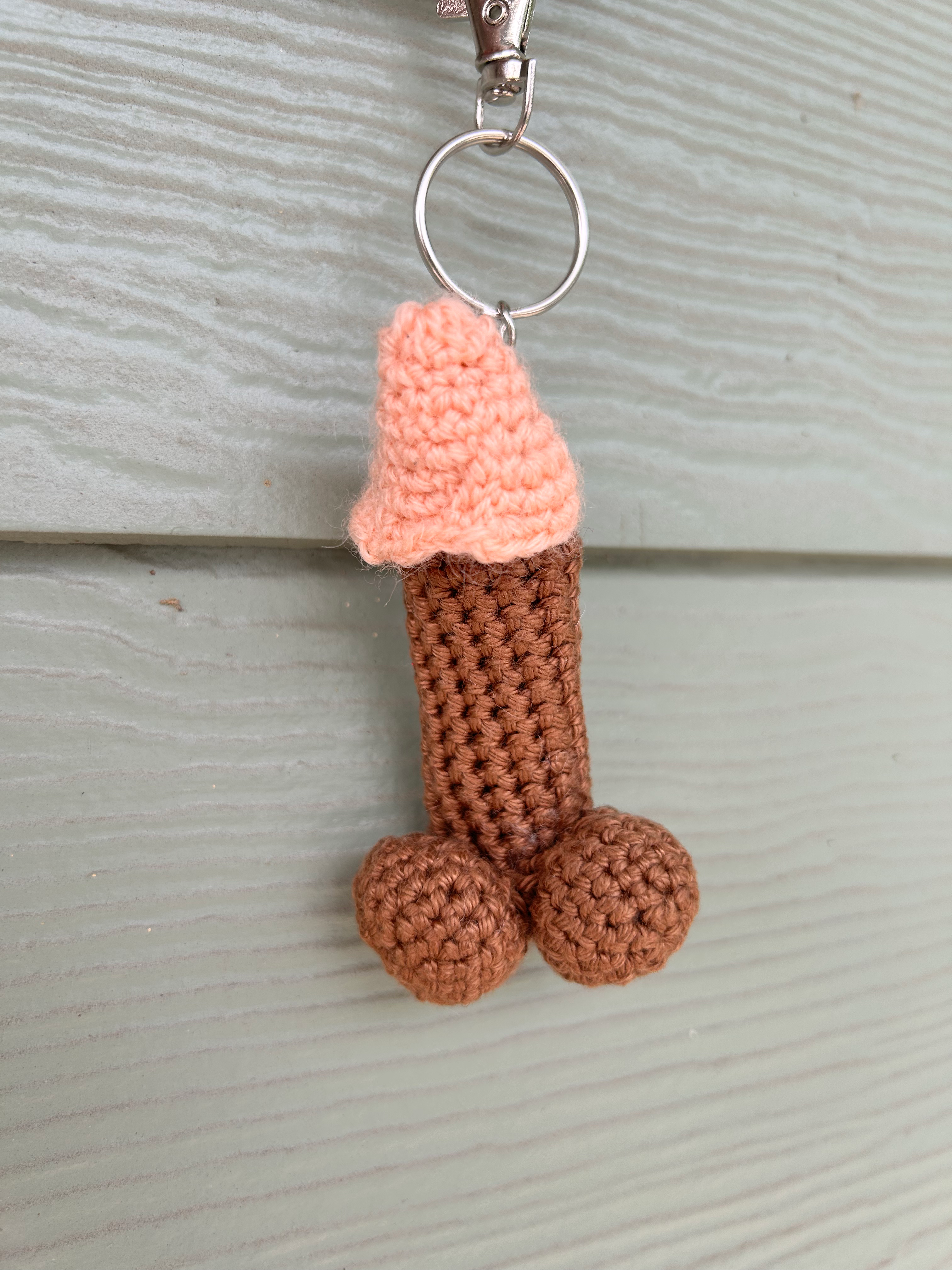 Marquis - Dark Brown ChapDick. Handmade crochet koozie for lip balm resembling phallus. LGBTQ-owned company in Brooklyn, NY.