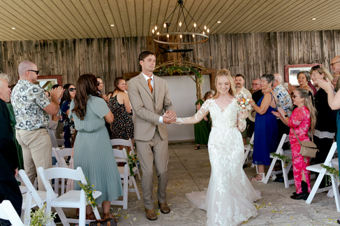 The groom glances with love and tears at his new bride.