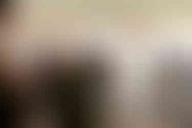 The groom glances with love and tears at his new bride.