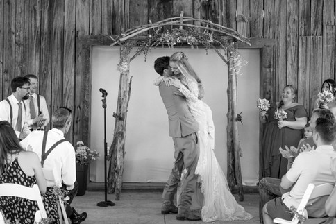 The groom glances with love and tears at his new bride.