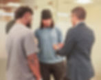 In this image, Maykon Dias is seen explaining dental care concepts to two professional rugby players in an informal setting. He is demonstrating using a dental model, highlighting the practical approach EasyDental takes to educate athletes about oral health. The players are engaged in the conversation, showing interest in how oral health can affect their performance.