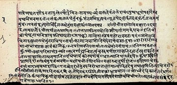 Eye-level view of an ancient Sanskrit manuscript with intricate script
