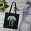 Thumbnail: organic cotton tote bag with vibrant surfboard & palm tree graphic coloured by a photo of nature