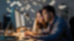a man and woman working hard at computer