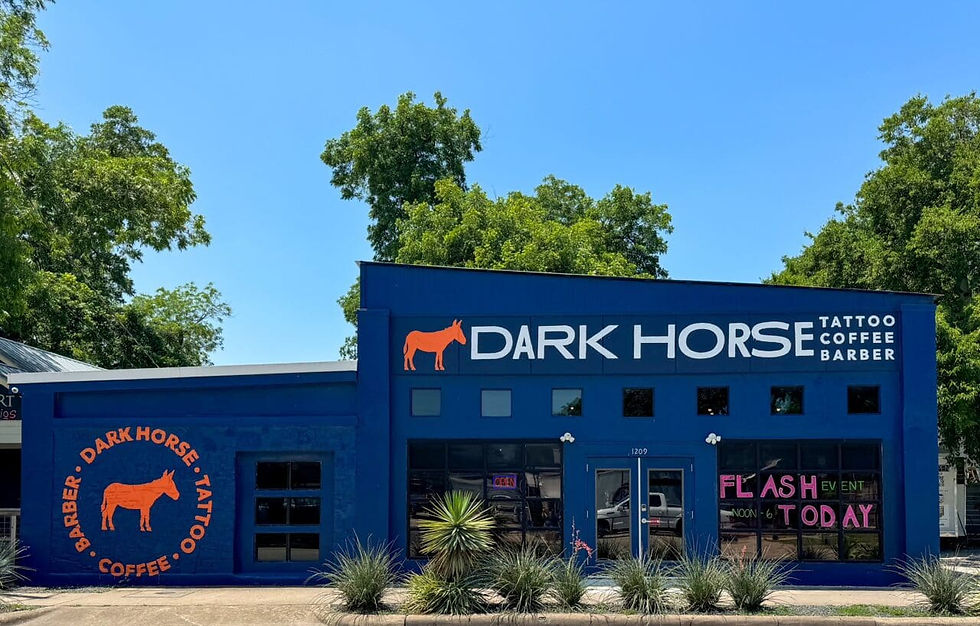 Interior of Dark Horse Tattoo, Coffee & Barber Co. with eclectic decor and a unique Austin vibe for office holiday gatherings.