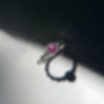 Curly gold ring with natural pink sapphire — sculpted wavy band, bezel setting.