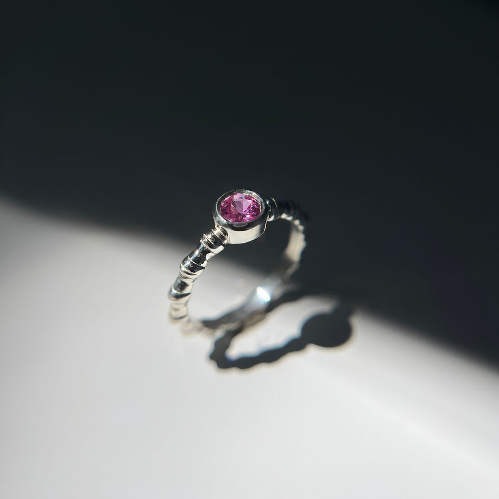 Handcrafted 14K gold ring with pink sapphire — organic texture, polished finish.