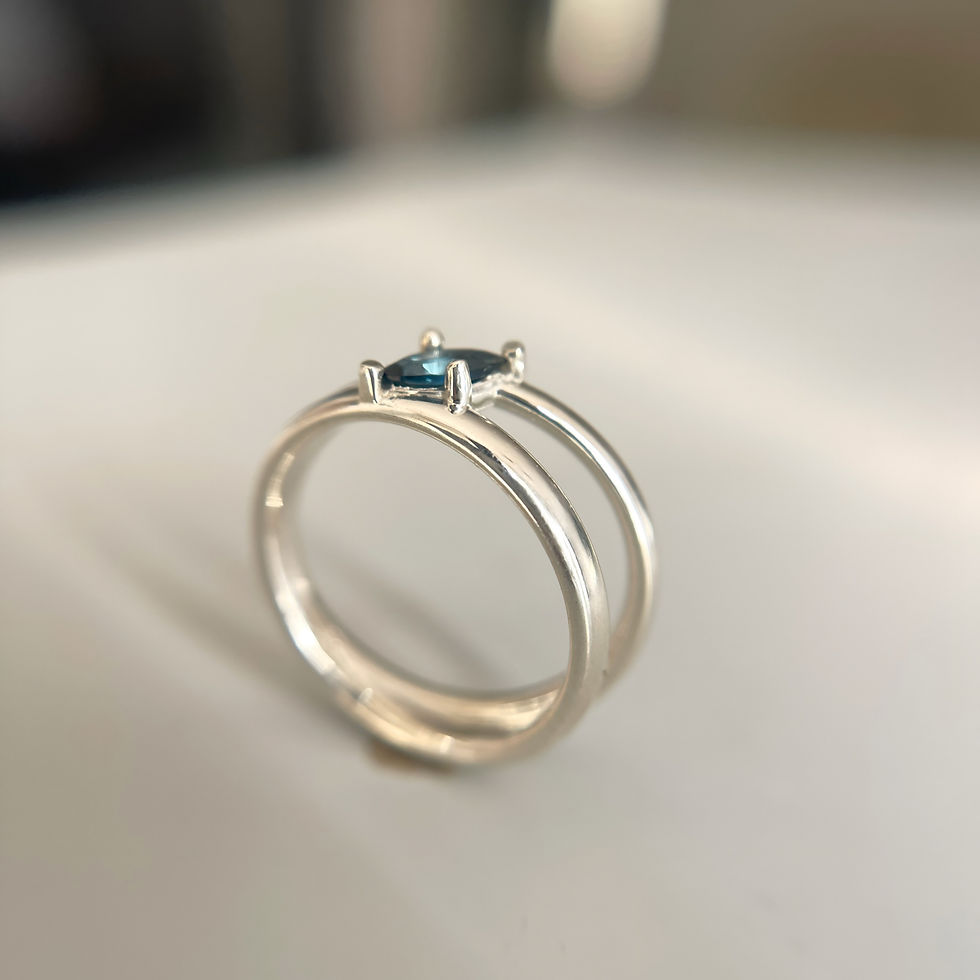 Thumbnail: Artistic view of Flow silver ring — sleek and fluid form with topaz centerpiece.