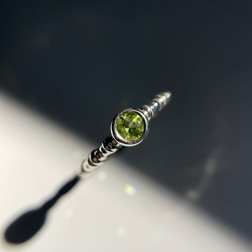 Handcrafted 14K gold ring with peridot — organic texture and soft glow