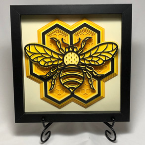 This bee is nestled on top of a honeycomb pattern.
