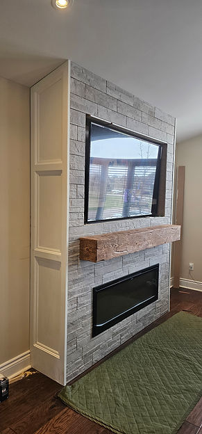 Built-in fireplace wall with hidden wiring and clean finish carpentry