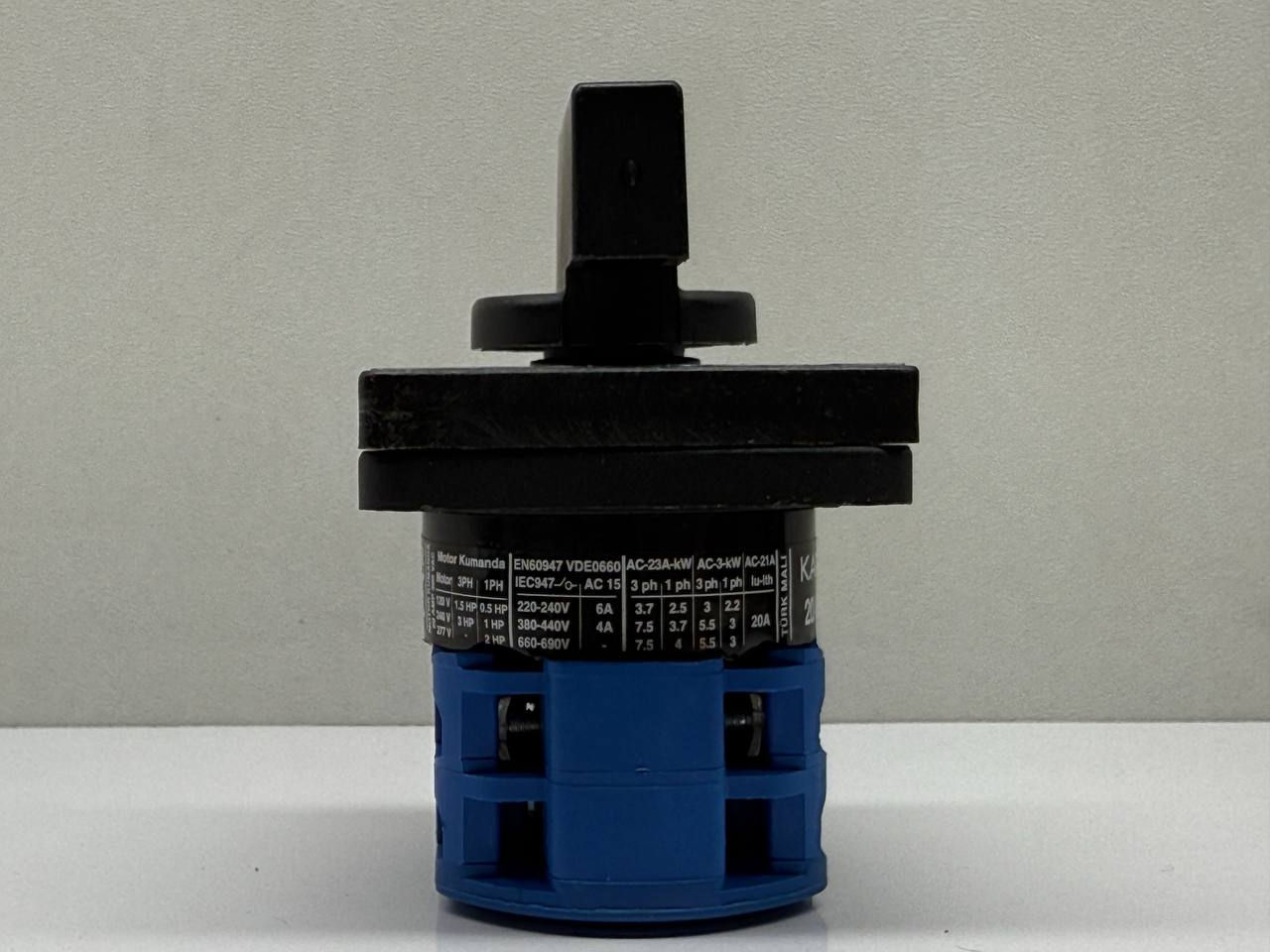 Black and blue electrical switch with text, industrial component, Voltek Shop.