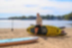 Moaki'i paddleboards laid out on lake Norman shore with man around