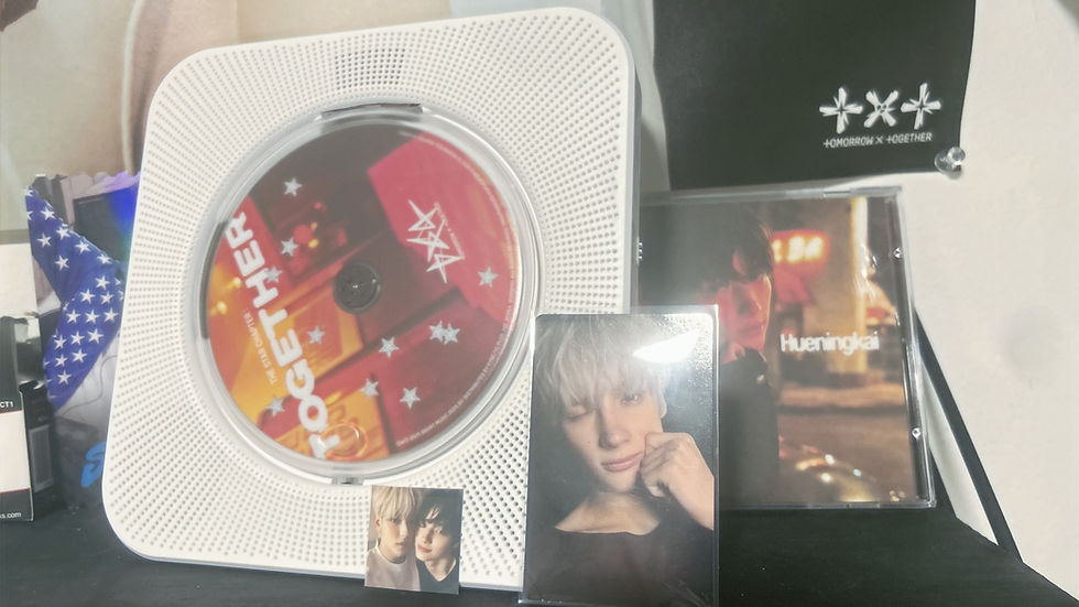 Shelf with a red "Together" CD in a white player, a photo card of a smiling person, and a CD cover with "Hueningkai" text.