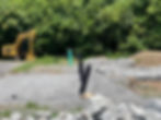 excavator and rock retaining wall