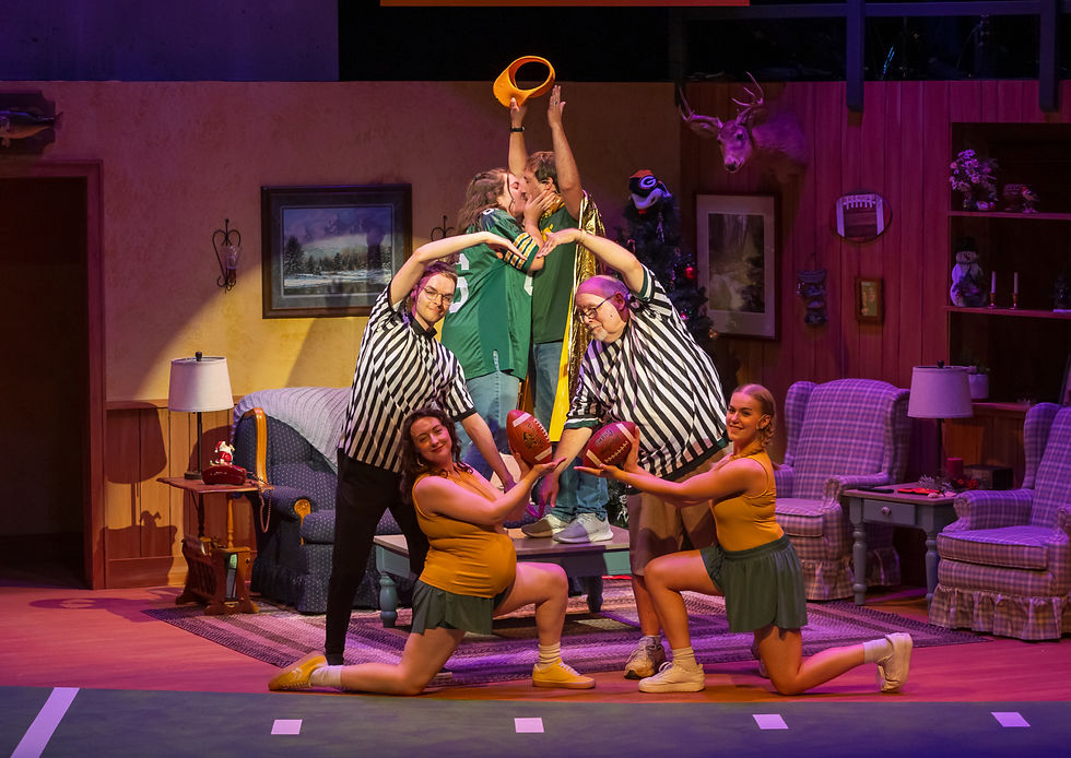 People dressed in football attire make a heart with their bodies while a couple kisses