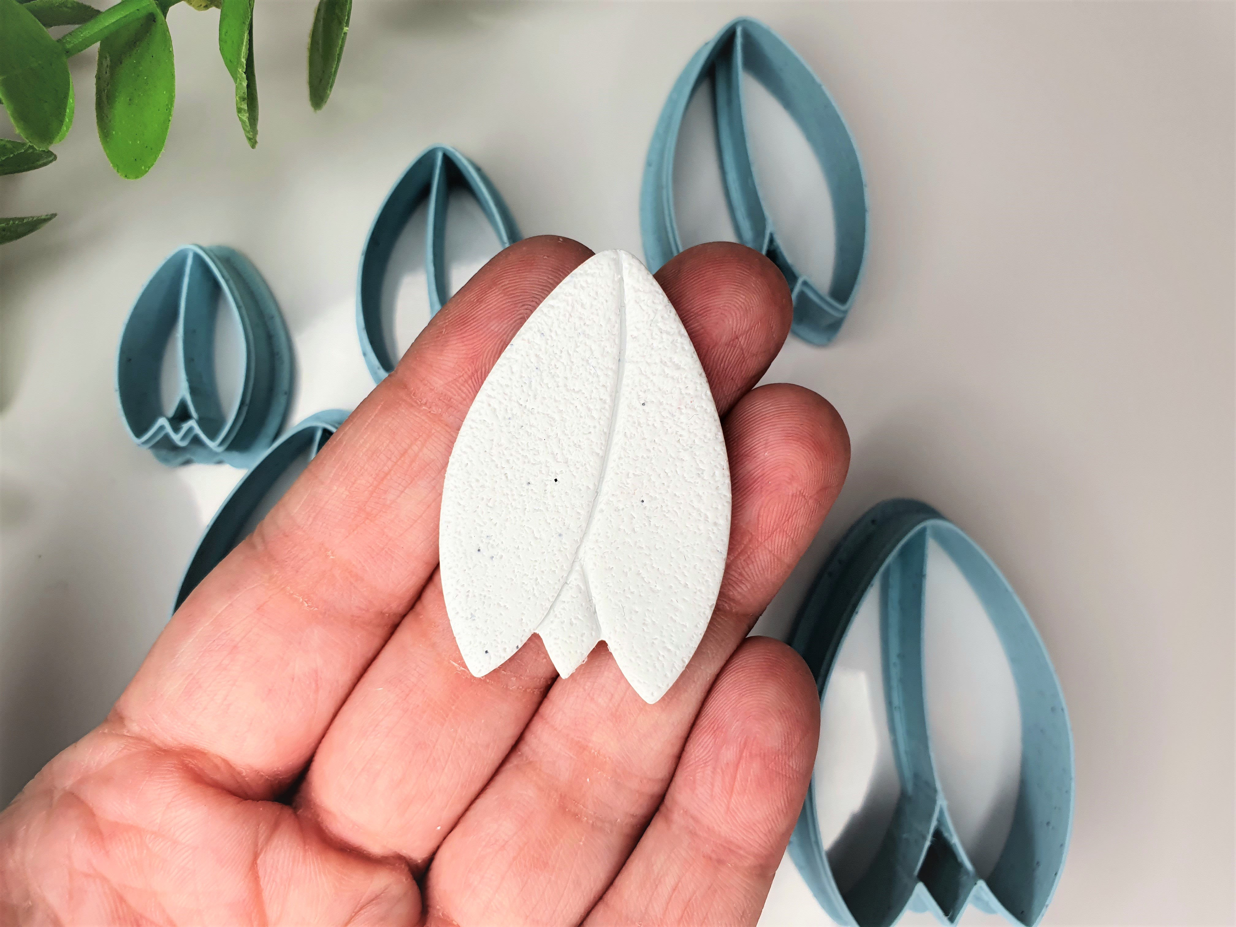 Tulip flower polymer clay shape shown in hand, shape made by a 3D printed tulip cutter