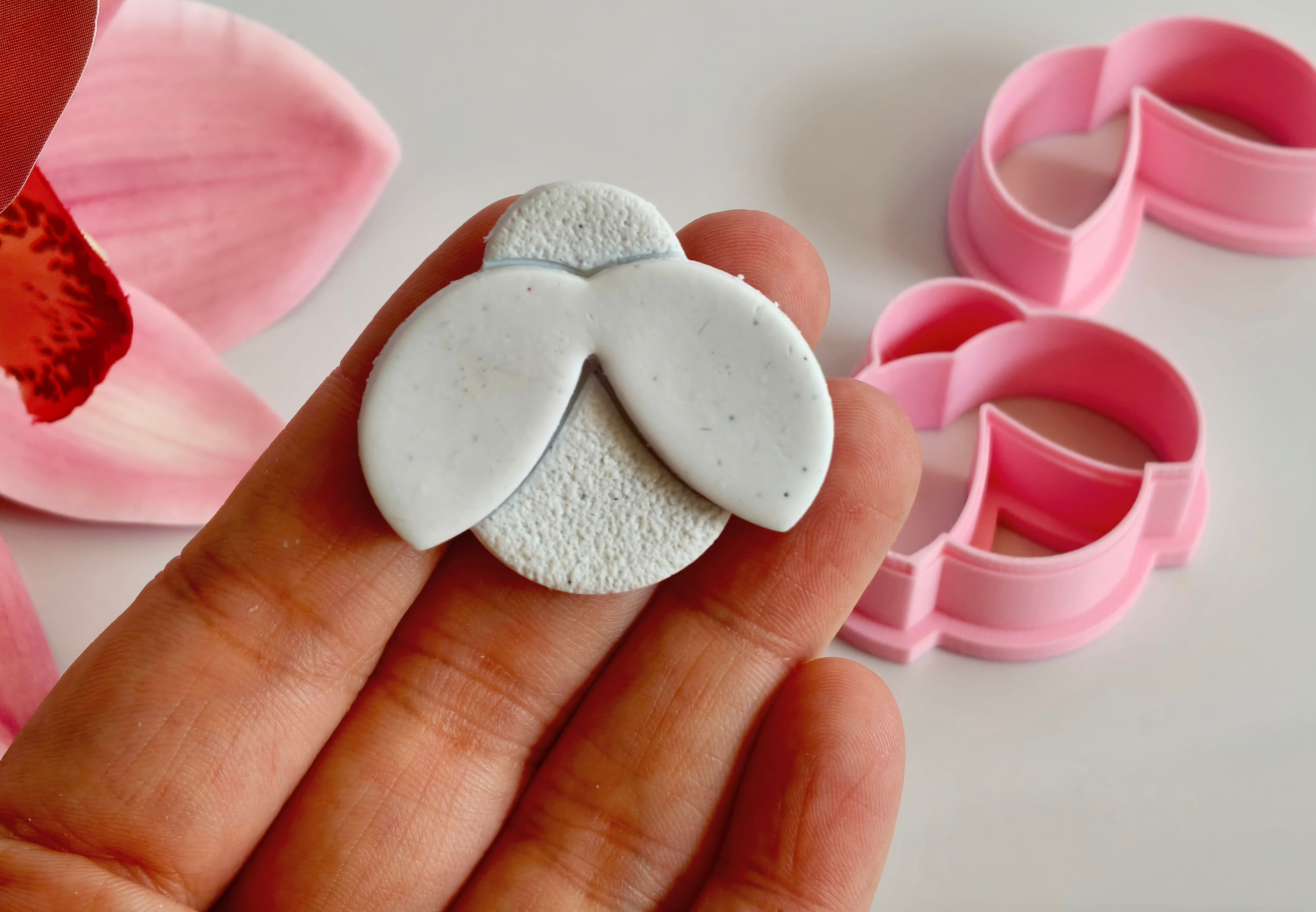 Ladybug polymer clay shape shown in hand, shape made by a 3D printed ladybug cutter