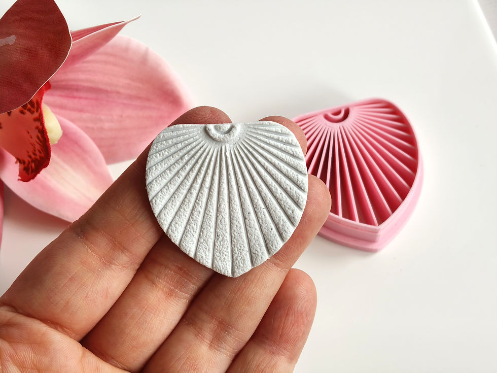 Leaf with lines polymer clay shape shown in hand, shape made by a 3D printed cutter