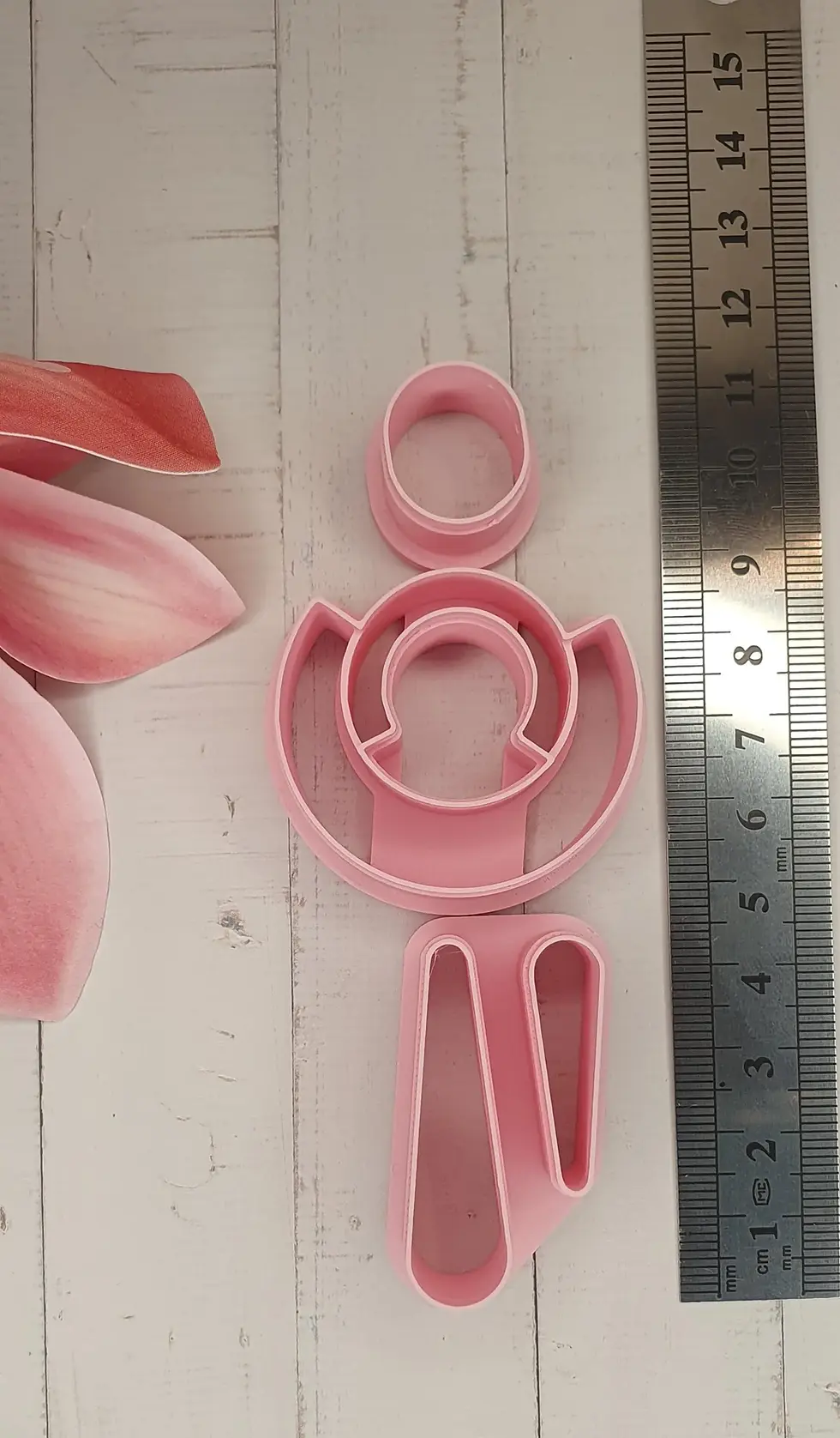 Human Dangle polymer clay cutter set, front view , next to a ruler, a 3D printed human dangle cutter