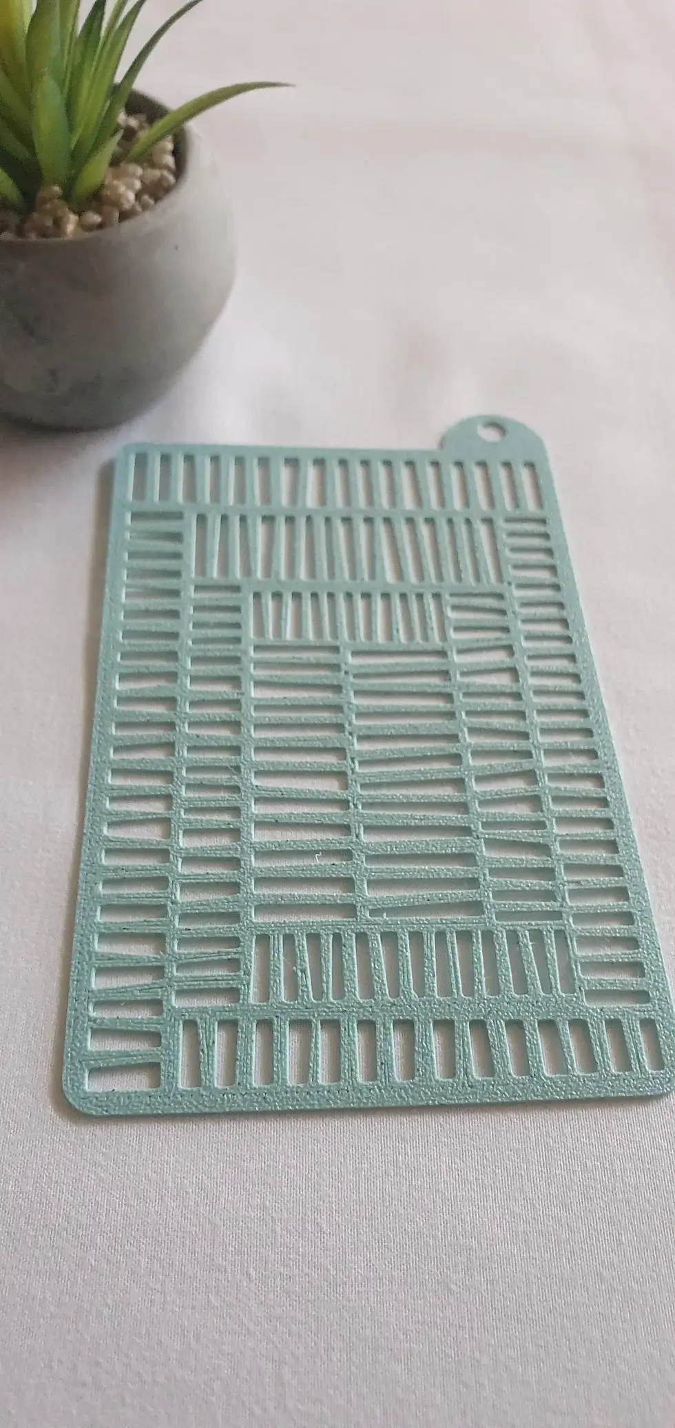 Close-up of 3D printed stencil showing raised texture geometric pattern