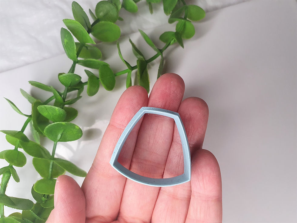 Thumbnail: Trapezoid polymer clay cutter shown in hand, front view, lightweight 3D printed tool for precise clay cutting