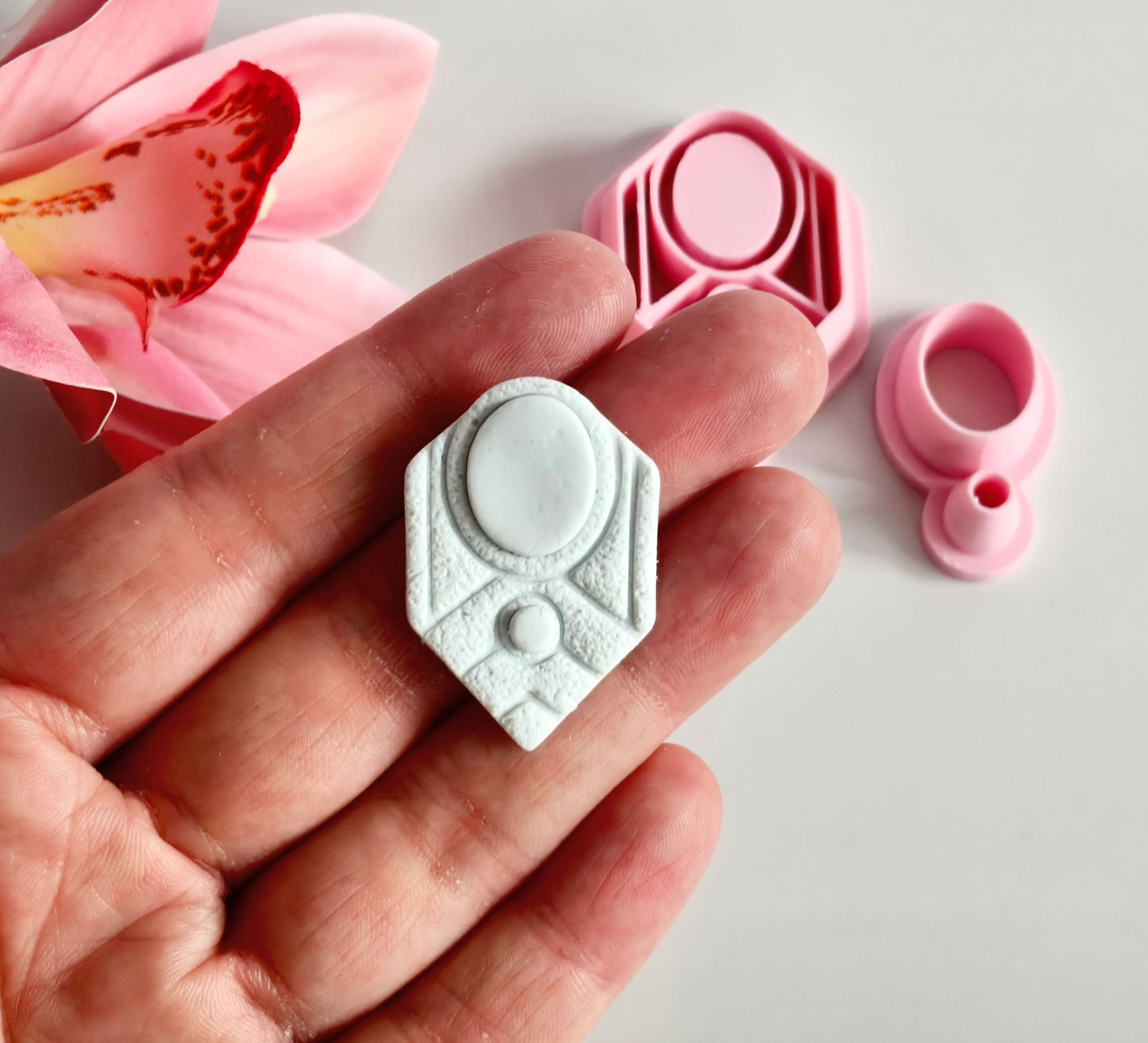 Art Deco with stone polymer clay shape shown in hand, shape made by a 3D printed art deco cutter