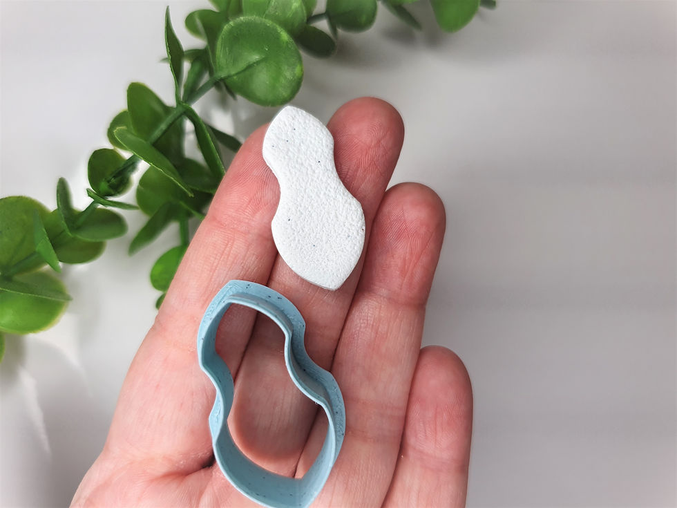 Thumbnail: Curved shield polymer clay shape shown in hand, shape and cutter,  made by a 3D printed cutter