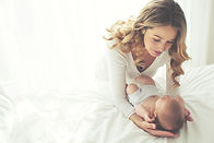 New mother looking at her newborn baby boy.